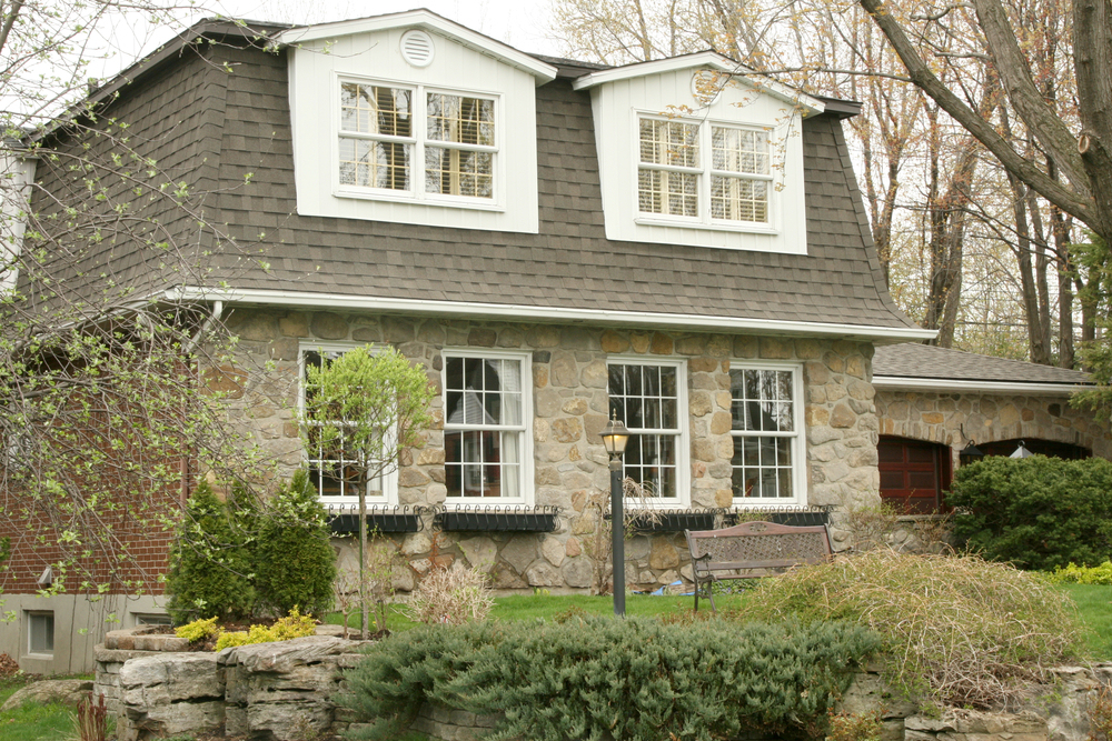 stone executive cottage with mansard roof
